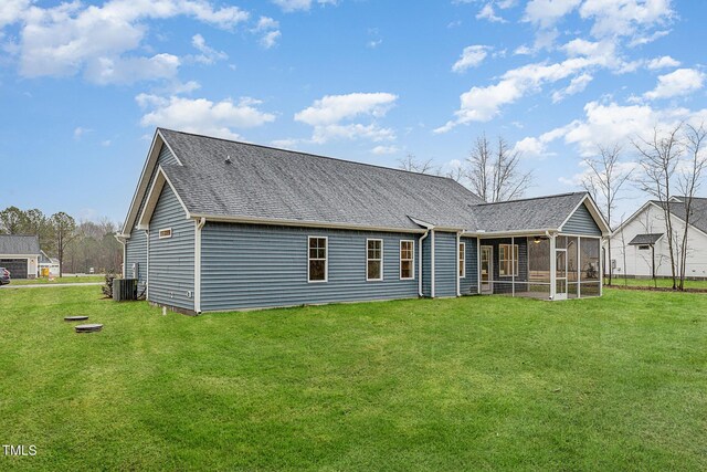 613 Tuscany Cir, Princeton, NC 27569 - rear view of house featuring a sunroom, a lawn, central AC unit, and roof with shingles