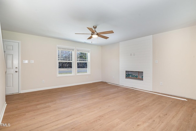 300 Tuscany Cir, Princeton, NC 27569 - unfurnished living room featuring a fireplace, light wood-style flooring, baseboards, and ceiling fan