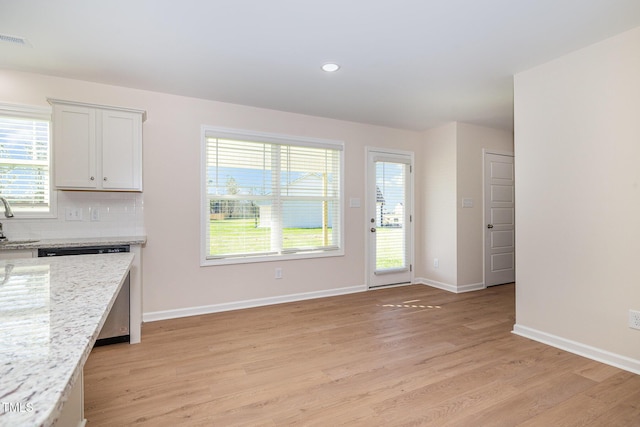 300 Tuscany Cir, Princeton, NC 27569 - unfurnished dining area with light wood-style floors, visible vents, a sink, baseboards, and plenty of natural light