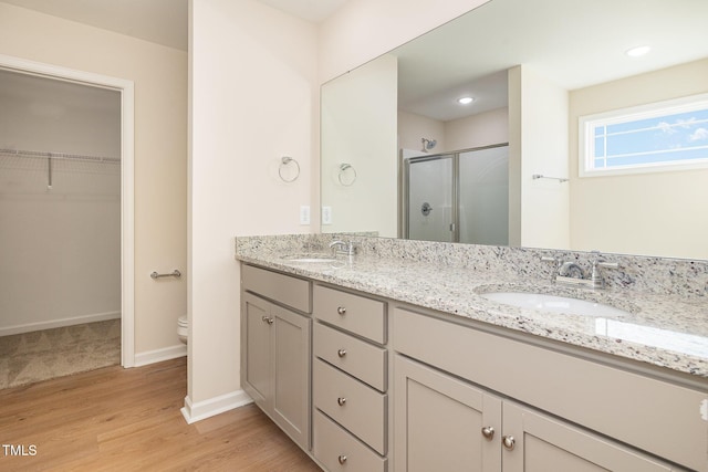 300 Tuscany Cir, Princeton, NC 27569 - full bath featuring a stall shower, wood finished floors, double vanity, and a sink
