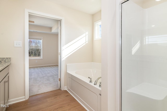 300 Tuscany Cir, Princeton, NC 27569 - full bath with a garden tub, vanity, a shower, wood finished floors, and baseboards
