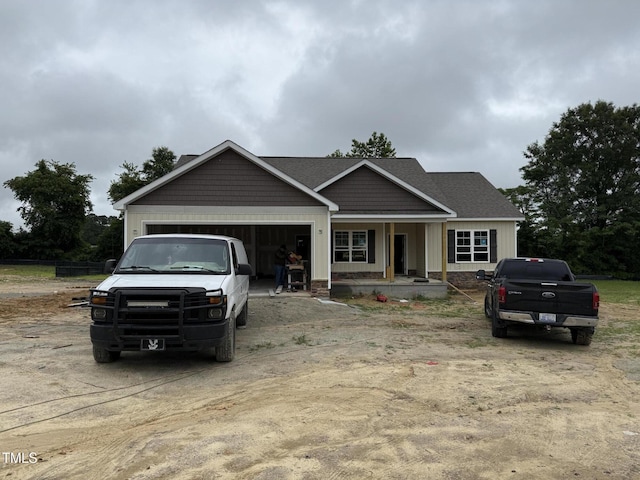 28 Bailey-Boykin Rd, Selma, NC 27576 - view of front facade featuring an attached garage, dirt driveway, and covered porch