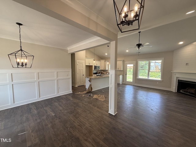 28 Bailey-Boykin Rd, Selma, NC 27576 - unfurnished living room with a chandelier, dark wood-style floors, ornamental molding, a ceiling fan, and a fireplace