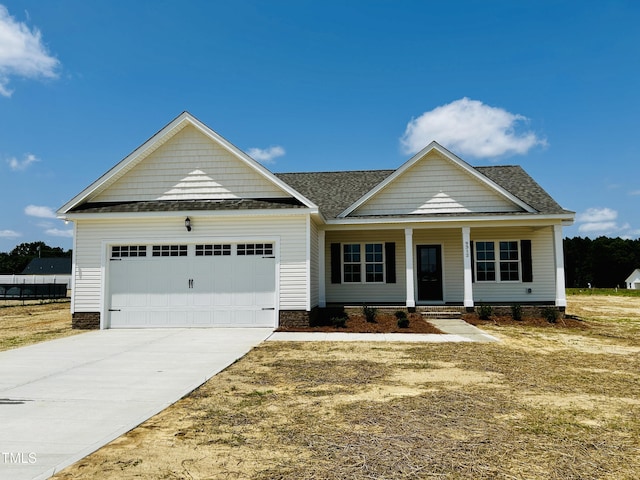 3912 Origin Dr, Bailey, NC 27807 - view of front of property featuring an attached garage, driveway, covered porch, and roof with shingles