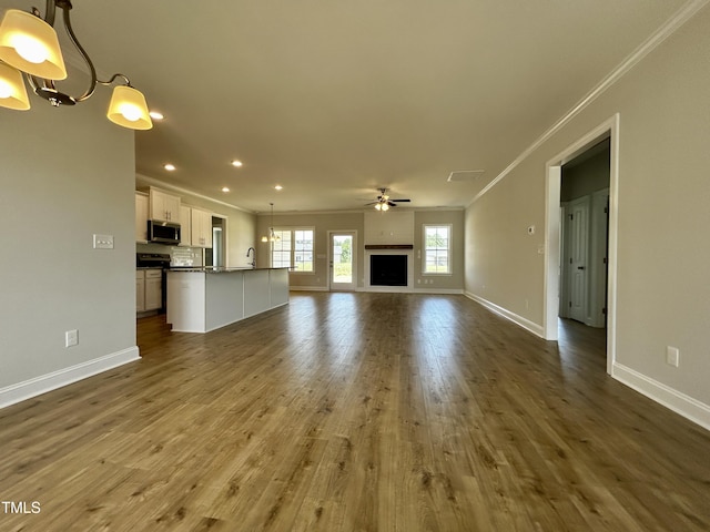 3912 Origin Dr, Bailey, NC 27807 - unfurnished living room featuring crown molding, a chandelier, recessed lighting, baseboards, and ceiling fan