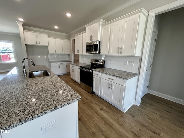 3912 Origin Dr, Bailey, NC 27807 - kitchen with stainless steel appliances, a sink, crown molding, white cabinets, and dark wood-type flooring