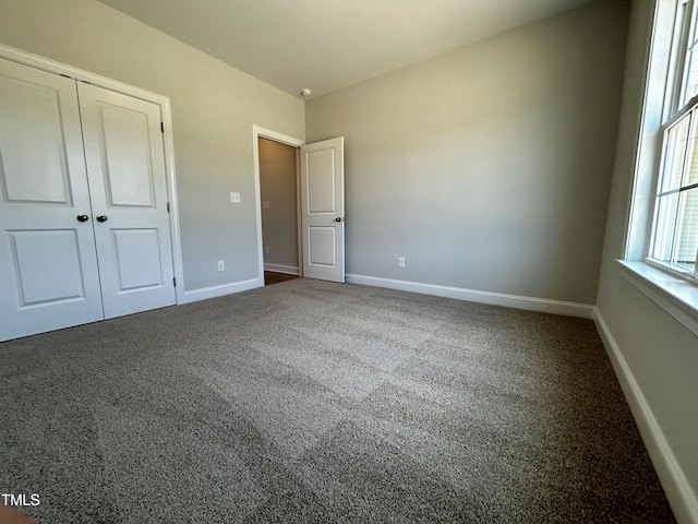 3912 Origin Dr, Bailey, NC 27807 - unfurnished bedroom featuring carpet floors, baseboards, and a closet