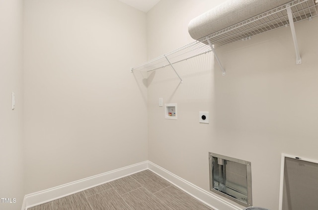 clothes washing area with laundry area, washer hookup, baseboards, and electric dryer hookup