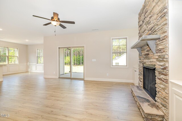 18 Bonnybrook Ct, Selma, NC 27576 - unfurnished living room featuring a fireplace, ceiling fan, and light wood-style floors