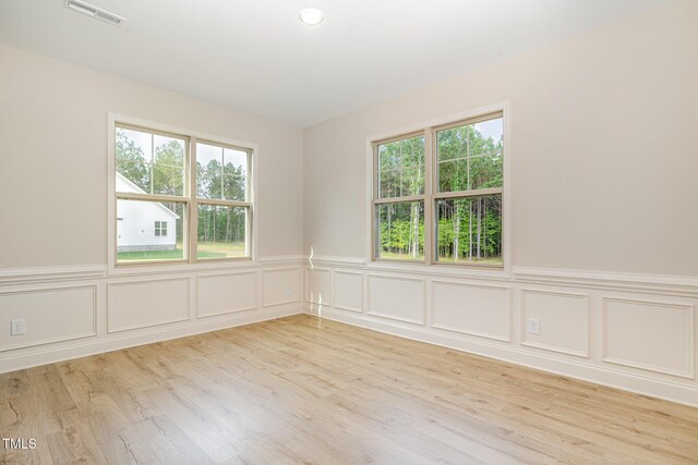 18 Bonnybrook Ct, Selma, NC 27576 - spare room with a wainscoted wall, light wood-style flooring, and a decorative wall