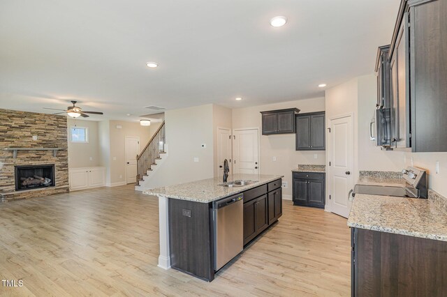 18 Bonnybrook Ct, Selma, NC 27576 - kitchen with stainless steel appliances, ceiling fan, light wood-style flooring, open floor plan, and light stone countertops