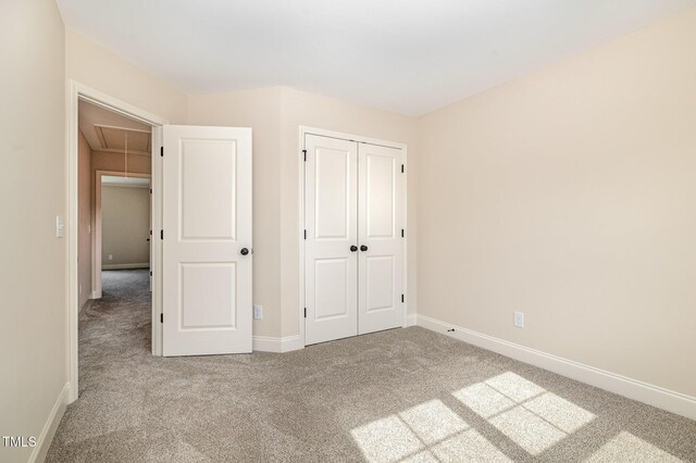 18 Bonnybrook Ct, Selma, NC 27576 - unfurnished bedroom with carpet floors, attic access, and a closet