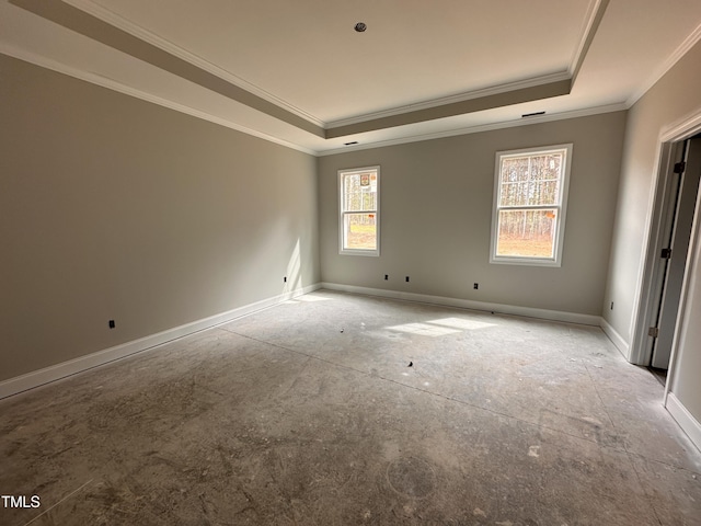 unfurnished room featuring baseboards, ornamental molding, and a raised ceiling