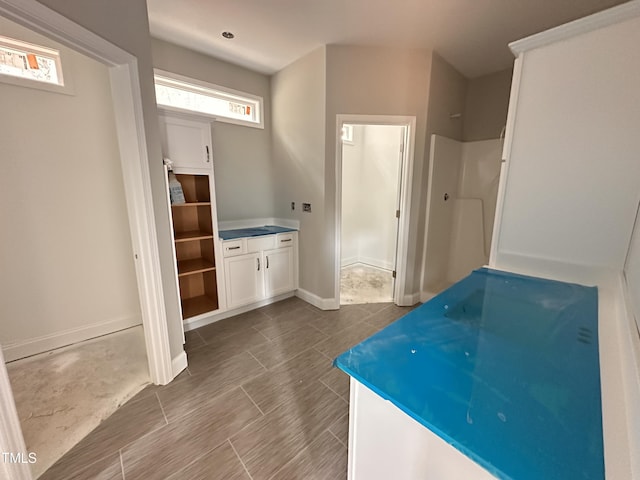 bathroom featuring walk in shower and baseboards