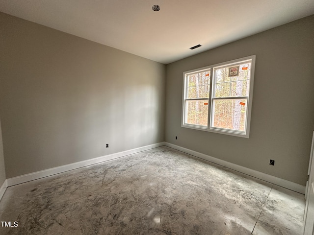 spare room featuring baseboards and visible vents