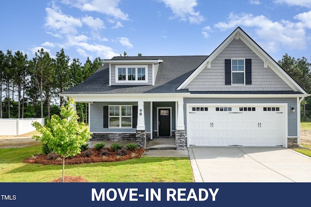 98 Laramie Ln, Selma, NC 27576 - craftsman-style house featuring stone siding, concrete driveway, covered porch, a shingled roof, and a garage