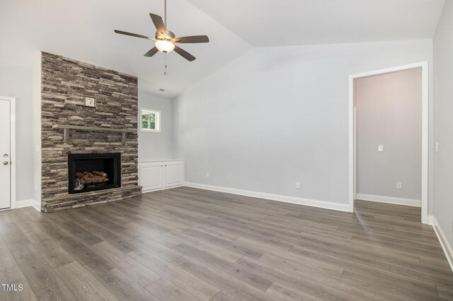 98 Laramie Ln, Selma, NC 27576 - unfurnished living room with ceiling fan, lofted ceiling, a fireplace, and wood finished floors