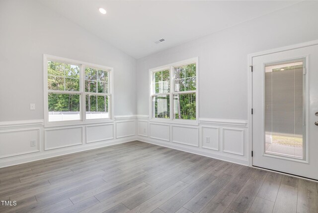 98 Laramie Ln, Selma, NC 27576 - spare room with wainscoting, lofted ceiling, and wood finished floors