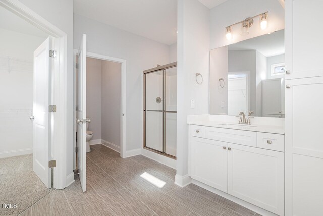 98 Laramie Ln, Selma, NC 27576 - bathroom with a spacious closet, a stall shower, and vanity