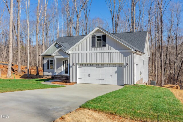 3027 Wesley Farm Ln, Sophia, NC 27350 - view of front of property with a front lawn, board and batten siding, concrete driveway, and roof with shingles