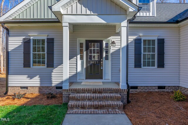3027 Wesley Farm Ln, Sophia, NC 27350 - view of exterior entry featuring board and batten siding, crawl space, and a shingled roof