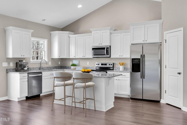 3027 Wesley Farm Ln, Sophia, NC 27350 - kitchen with white cabinets, a breakfast bar, a kitchen island, appliances with stainless steel finishes, and dark wood-style floors