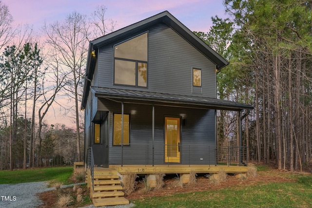 view of front of house with covered porch, a standing seam roof, and metal roof