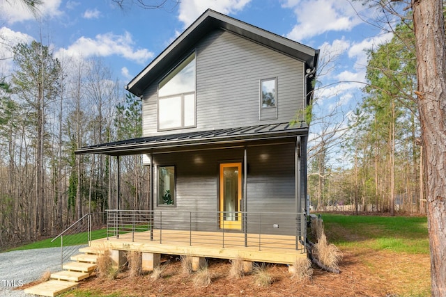 contemporary house with metal roof, covered porch, and a standing seam roof