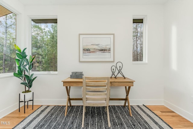 office space featuring baseboards and wood finished floors
