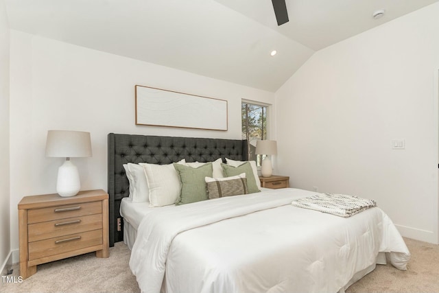 bedroom with light carpet, baseboards, vaulted ceiling, and a ceiling fan