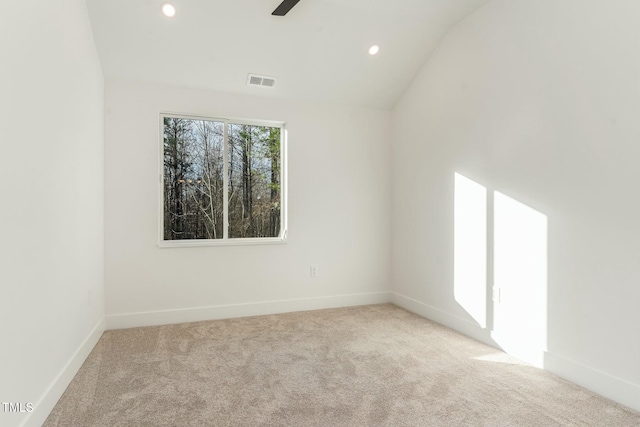 empty room with vaulted ceiling, recessed lighting, light colored carpet, baseboards, and visible vents