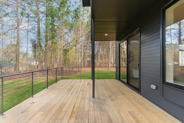 wooden terrace with a lawn