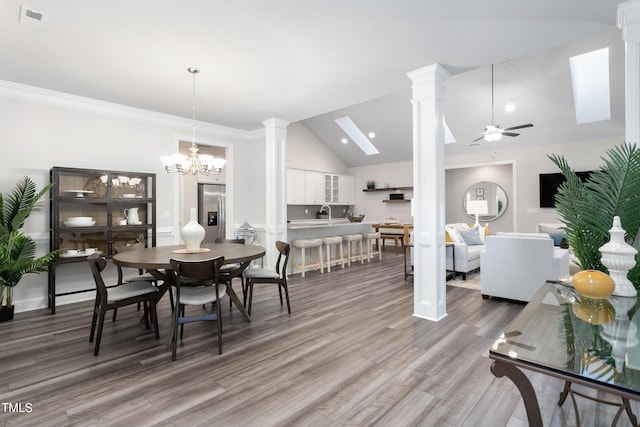 1053 Beechcraft Dr Unit 124, Mebane, NC 27302 - dining room featuring visible vents, decorative columns, lofted ceiling, light wood-type flooring, and ceiling fan with notable chandelier