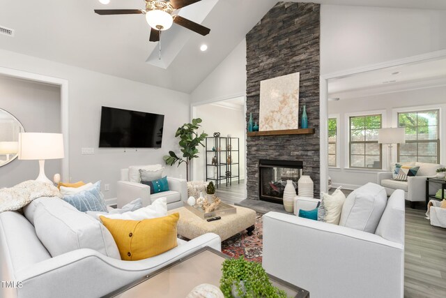 1053 Beechcraft Dr Unit 124, Mebane, NC 27302 - living area with high vaulted ceiling, a fireplace, wood finished floors, visible vents, and ceiling fan