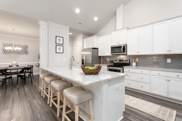 1053 Beechcraft Dr Unit 124, Mebane, NC 27302 - kitchen with a sink, tasteful backsplash, a kitchen breakfast bar, appliances with stainless steel finishes, and visible vents