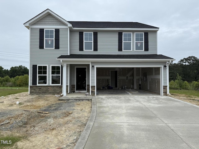43 Chloe Ct, Selma, NC 27577 - view of front of house with concrete driveway, stone siding, and a garage