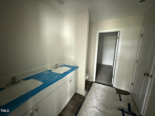 43 Chloe Ct, Selma, NC 27577 - bathroom featuring toilet, double vanity, and baseboards