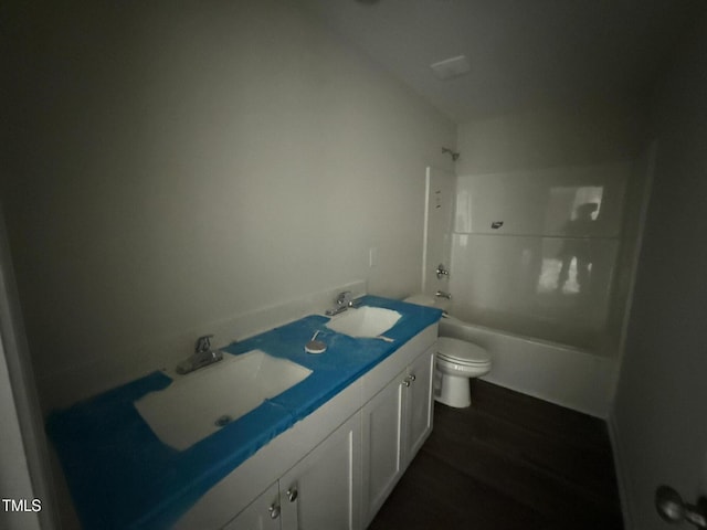 43 Chloe Ct, Selma, NC 27577 - bathroom with toilet, double vanity, wood finished floors, and tub / shower combination