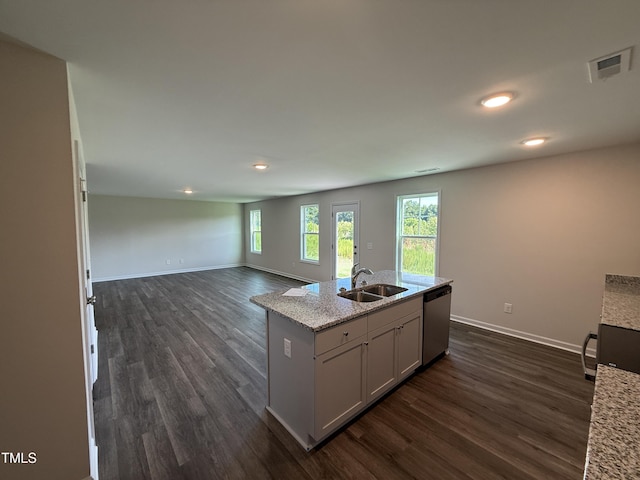43 Chloe Ct, Selma, NC 27576 - kitchen with dishwasher, dark wood finished floors, recessed lighting, open floor plan, and light stone countertops