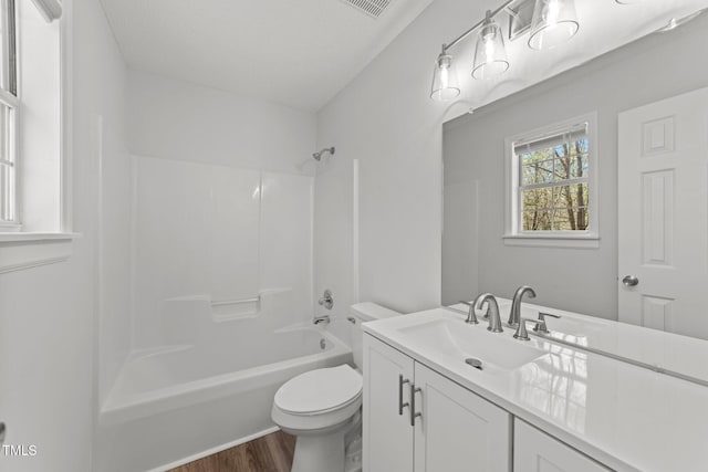 5408 Rivercrest Dr, Youngsville, NC 27596 - bathroom featuring vanity, toilet, shower / washtub combination, visible vents, and wood finished floors