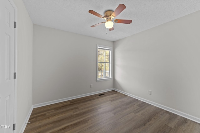 5408 Rivercrest Dr, Youngsville, NC 27596 - spare room featuring a textured ceiling, dark wood-style floors, ceiling fan, and baseboards