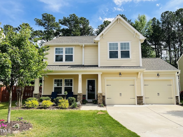 303 Fortress Dr, Morrisville, NC 27560 - craftsman-style house featuring fence, stone siding, a porch, a front yard, and concrete driveway