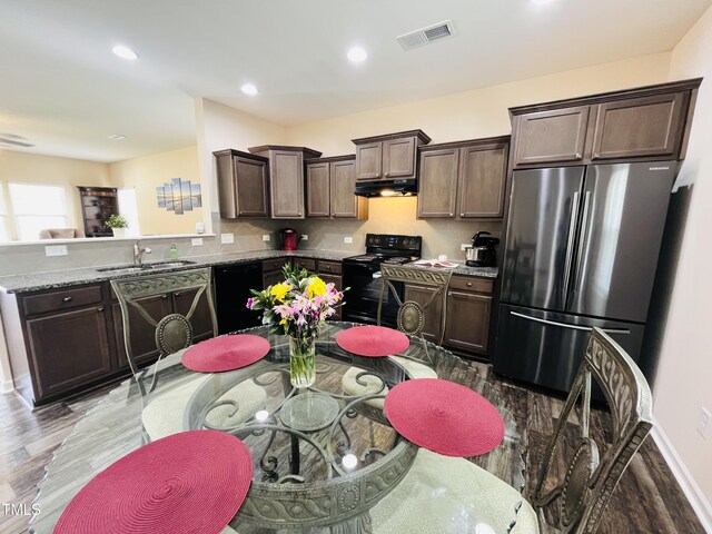 303 Fortress Dr, Morrisville, NC 27560 - kitchen with visible vents, dark brown cabinetry, under cabinet range hood, a sink, and black appliances