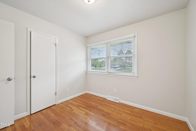 unfurnished bedroom with light wood-style floors, baseboards, and visible vents
