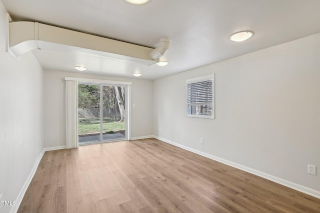 unfurnished room featuring light wood finished floors and baseboards