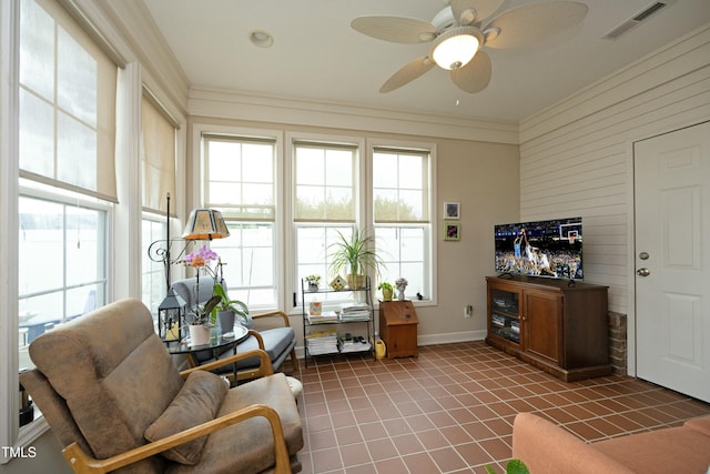 interior space featuring visible vents, baseboards, ornamental molding, ceiling fan, and light tile patterned floors