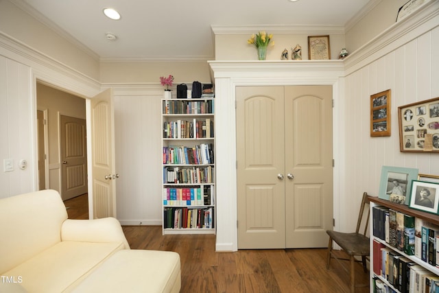 sitting room with wood finished floors and ornamental molding