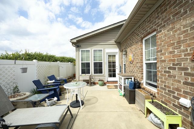view of patio with entry steps and fence