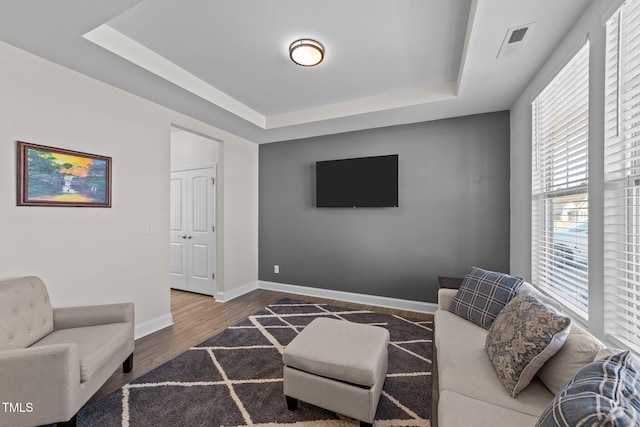 1408 Weavers Trace Dr, Zebulon, NC 27597 - living room with a raised ceiling, wood finished floors, baseboards, and visible vents