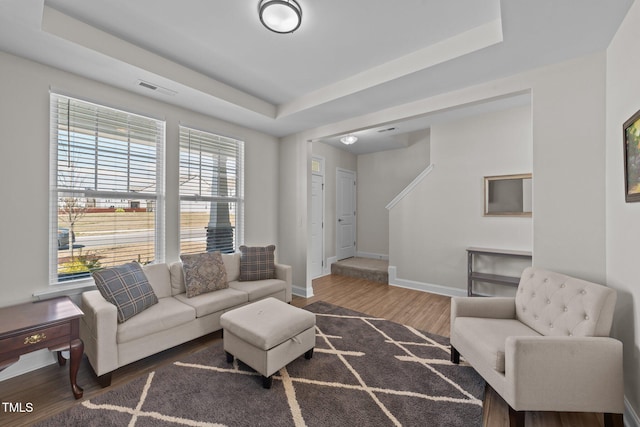 1408 Weavers Trace Dr, Zebulon, NC 27597 - living area featuring baseboards, visible vents, wood finished floors, and a raised ceiling